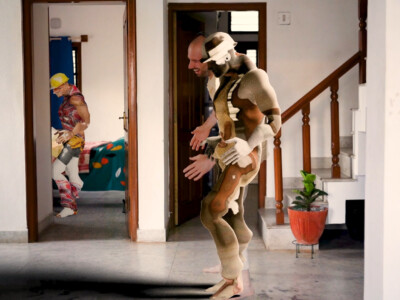 Digital still from the short film spot healing. The still includes a human, smiling and appearing to be mid-step. A 3D-modeled avatar mimics the movement right in front of him.
